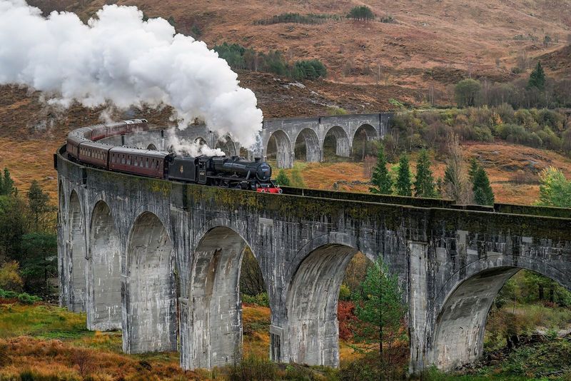 A steam train crossing the Glenfinnan Viaduct