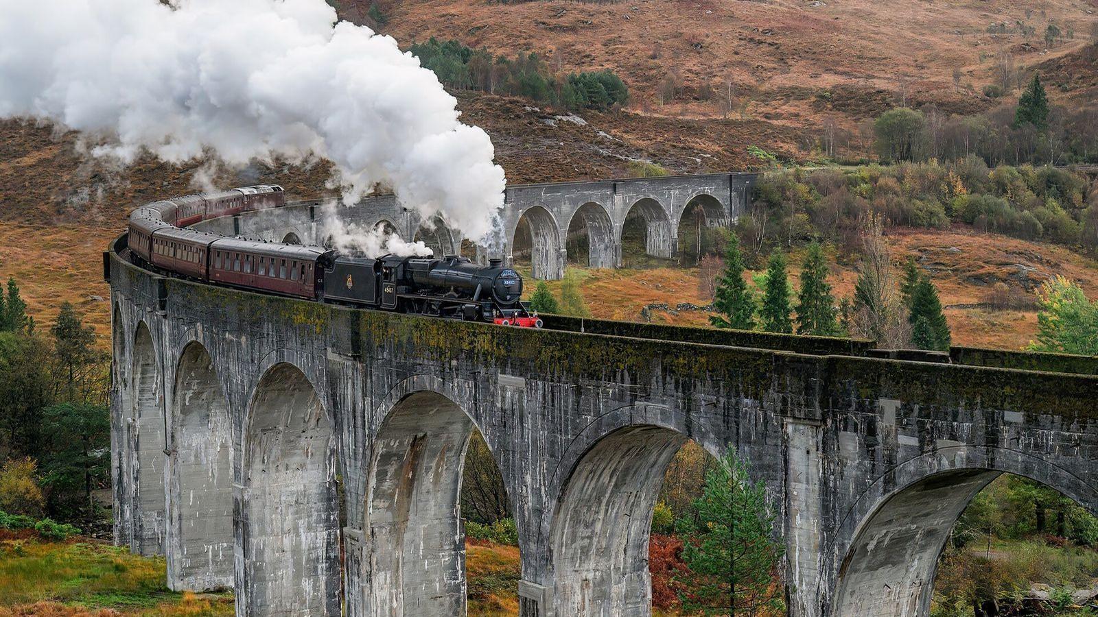 Steam train crossing the Glenfinnan Viaduct in the Scottish Highlands